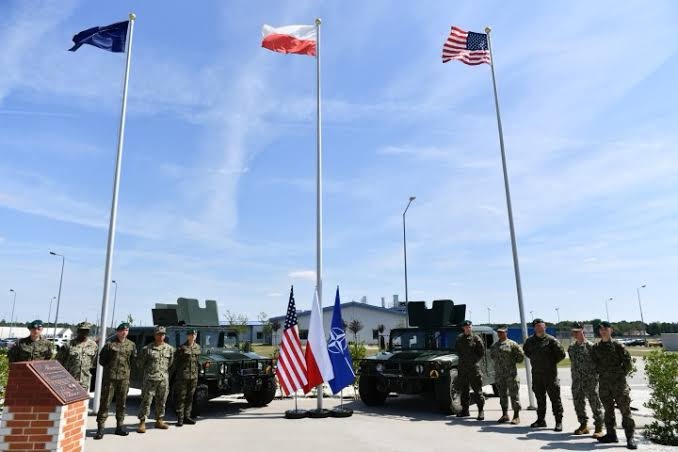 United States and Polish soldiers pose in front of the new missile base in Redzikowo, Poland.