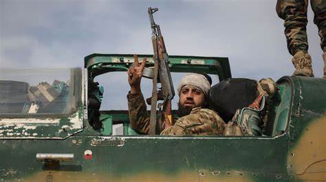 A Syrian rebel celebrating with Ak-47 rifle