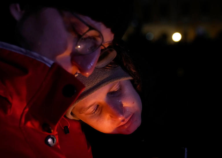 People paying their last respect outside Magdeburg Cathedral on Saturday evening