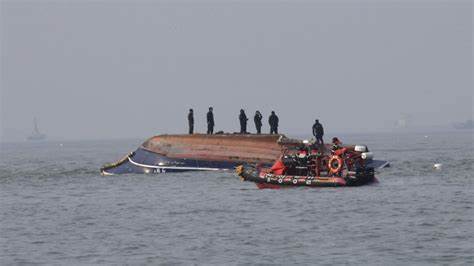 South Korean Coast Guards Standing on the capsized fishing vessel