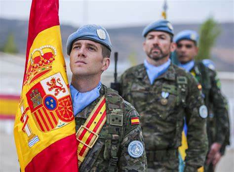 Spain military police soldiers hoisting Spain national flag